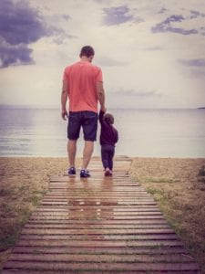 Father and child near lake