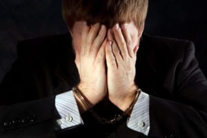 Man covering face in despair
