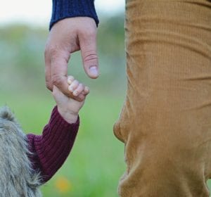 father holding child's hand