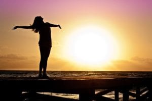 Woman stretching on pier