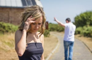 a man walking angrily away from a woman