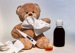 Teddy bear and medicine for a sick child
