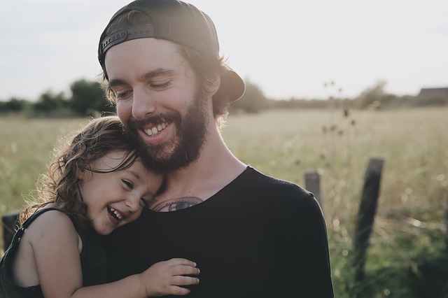 Man holding young daughter