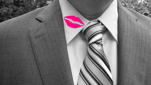 Man in suit with lipstick on collar