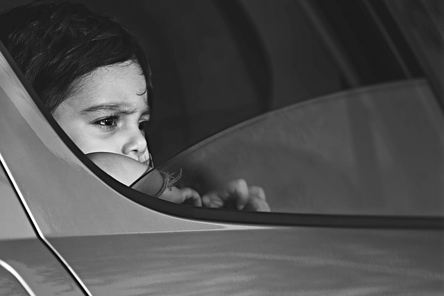 Kid looking out vehicle window