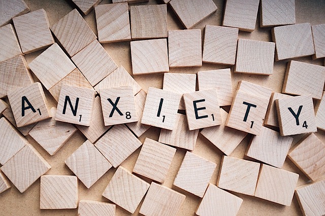 Scrabble tiles turned up to reveal the word "Anxiety"