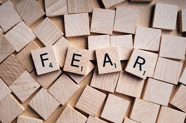 Scrabble tiles turned up to spell the word "Fear"