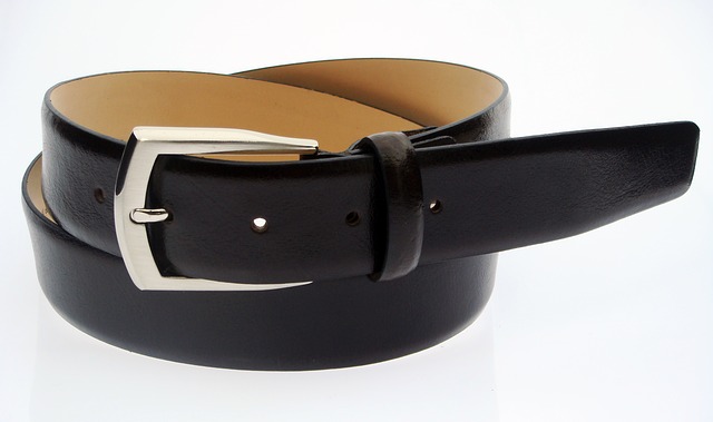 A rolled up belt with the buckle visible, symbolizing spanking as a controversial method of discipline that divorced parents sometimes disagree on.
