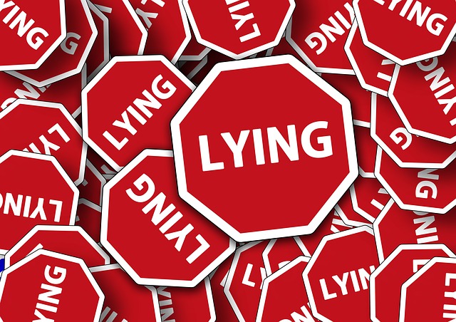 A pile of red hexagonal signs that all say "lying" on them