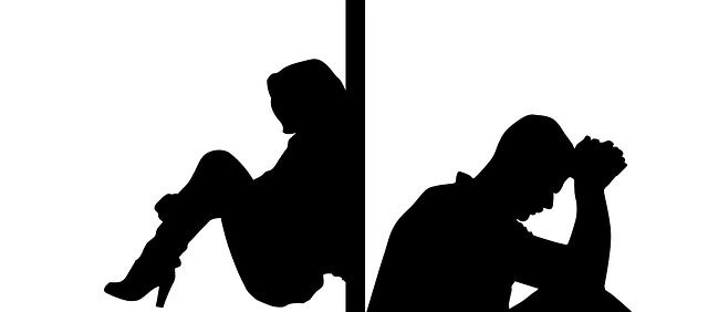 A black and white silhouette of a man and woman sitting with their backs to each other and a wall between them