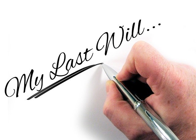 A close up of a hand writing out the words "my last will..."