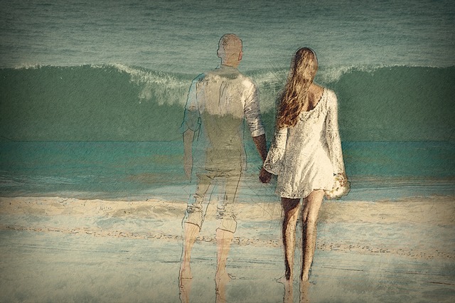 A woman on a beach holding hands with a man who is fading away in the picture.