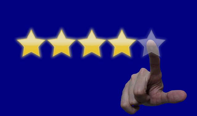 A finger clicking stars, like giving a review. 4 stars are lit up and the hand is about to touch the 5th one.